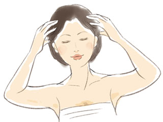 頭をマッサージする女性