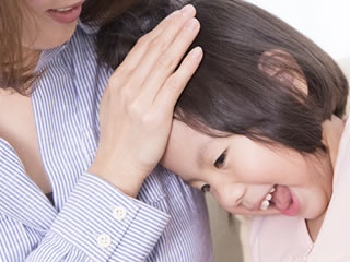 母親に撫でられ喜ぶ子供