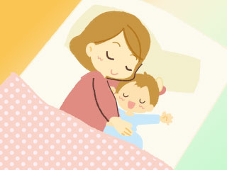 寝床で赤ちゃんを抱き寄せる母親