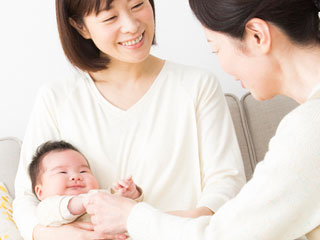 年女性二人が赤ちゃんを世話する
