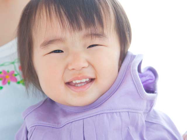 自分で上着を脱ぐ幼児