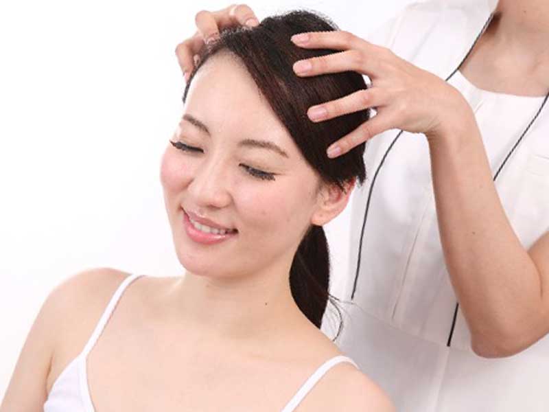 美容室で頭皮ケアをしている女性