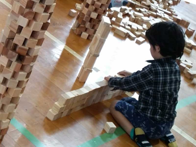 幼稚園で積み木で遊ぶ子供