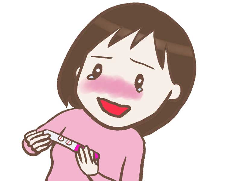 妊娠検査薬を見て喜ぶ女性