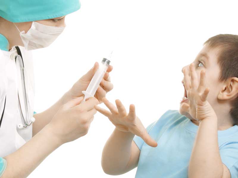 医師に注射されるのを怖がる子供