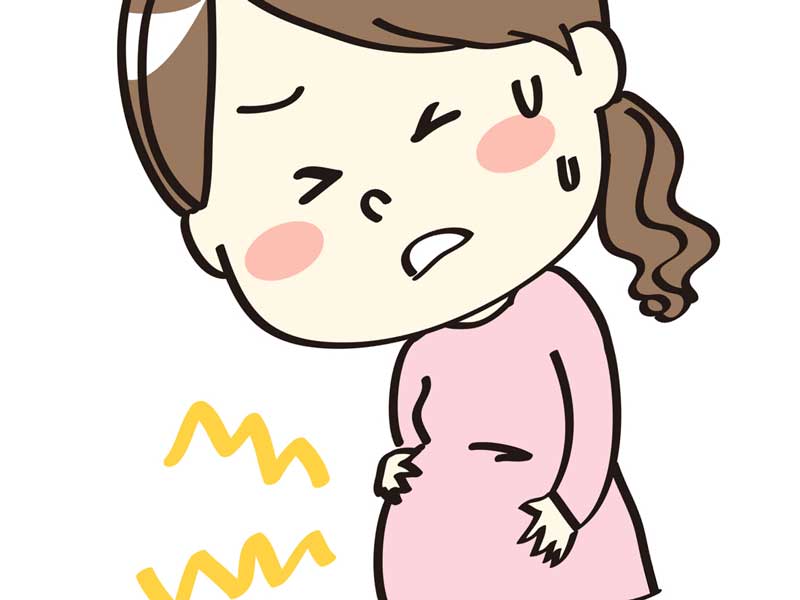 陣痛の痛みでお腹をおさえる妊婦さんのイラスト