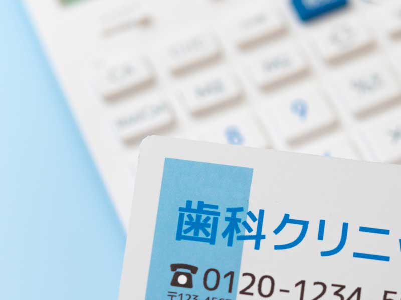 電卓と歯科クリニックの名刺