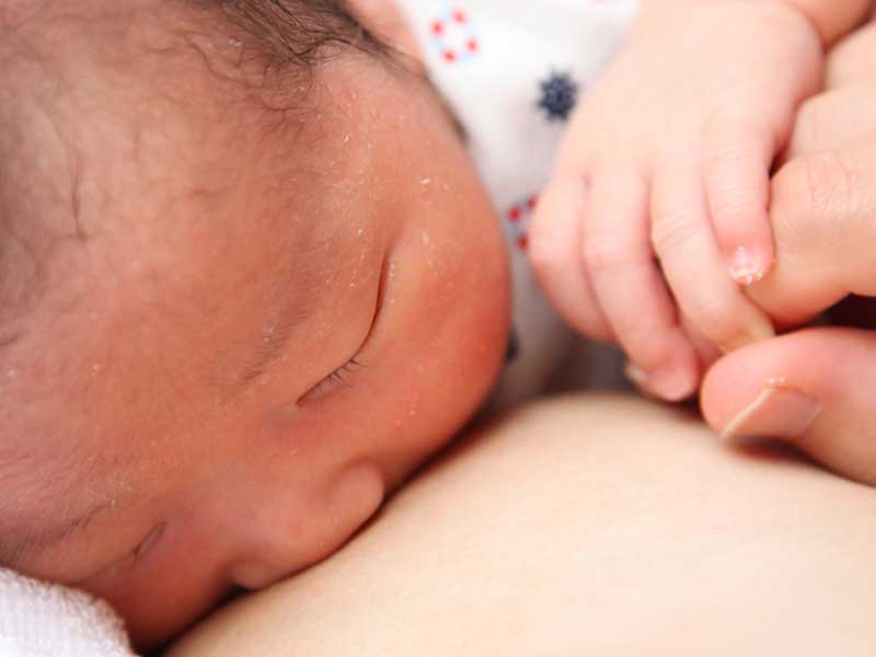 母乳を飲んでいる新生児