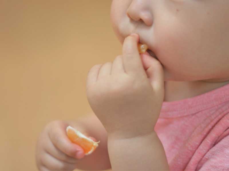 みかんを食べる赤ちゃん