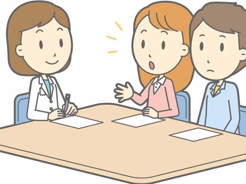 医師と相談する夫婦のイラスト