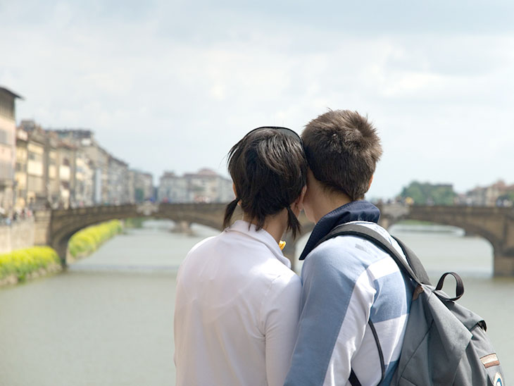 橋を見る若いイタリア人カップル