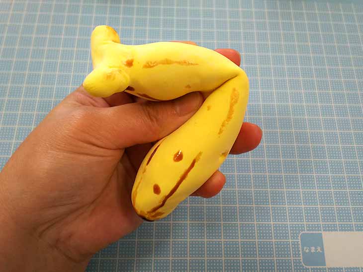 完成したエンジェルクレイのバナナのスクイーズを握る様子