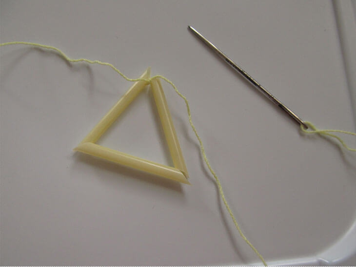 ストロー3つに糸を通して結んだ三角のヒンメリパーツ